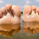 Feet poking out of lake water